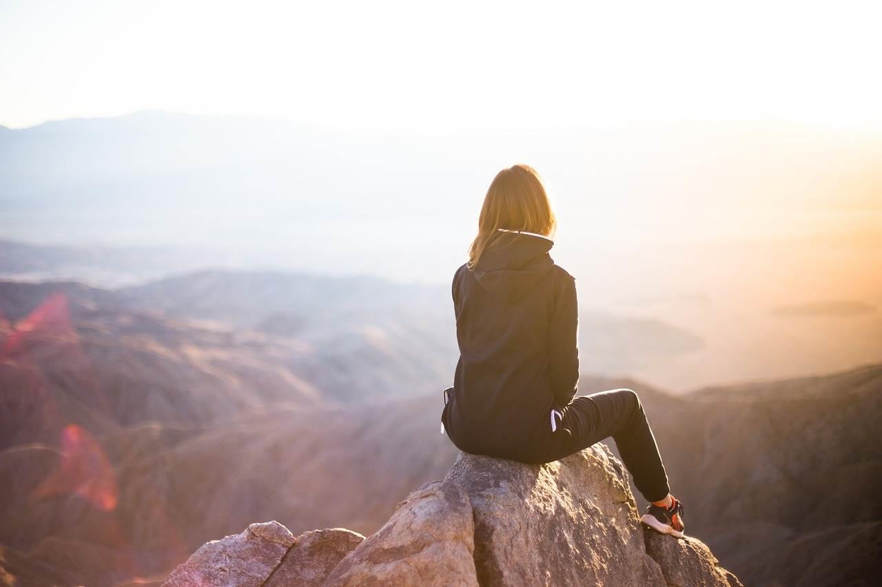 Mujer escalando una montaña. Pixabay