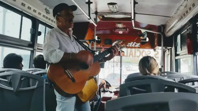 Cantar en los camiones urbanos es un arte para Rogelio Payán, que despierta nostalgia y placer auditivo. Con guitarra en mano, transforma simples trayectos en mágicas experiencias musicales. Foto: Juan Madrigal