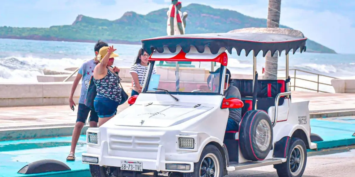 Turistas paseando por el malecón de Mazatlán.