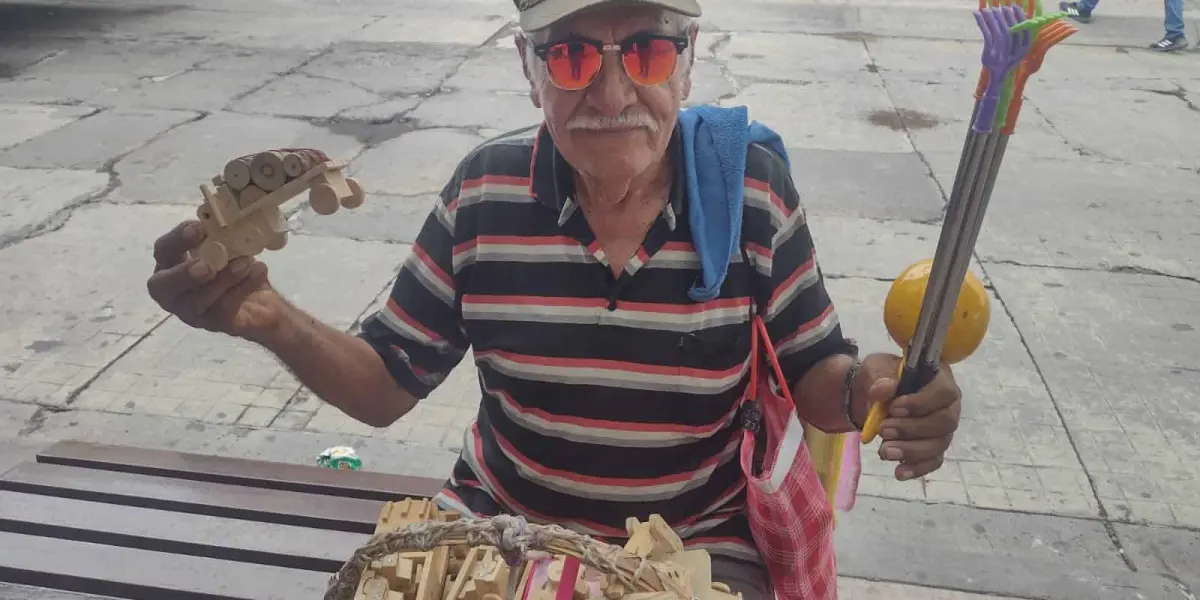 Don Lalo vende sus carritos de madera. Alegra a los niños de la ciudad y su corazón se llena de dicha cada día.