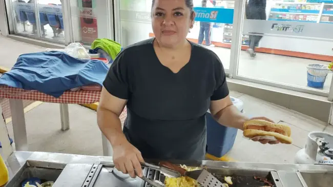 Patricia agradece a los clientes que dan vida a su negocio de hot dogs. Fotos: Francisco Castro