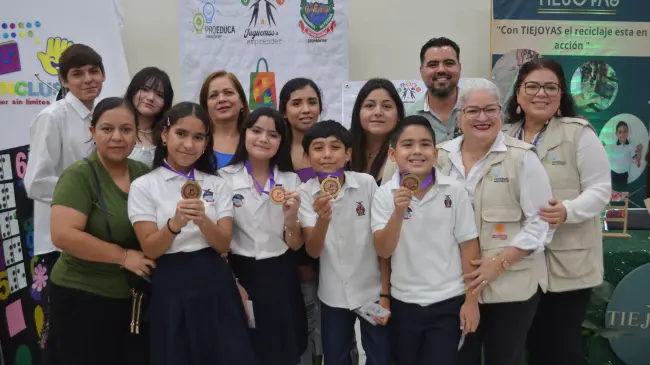 El equipo de Plastiqué, de la primaria Niños Héroes, celebra su primer lugar en Juguemos Emprender 2025 con su propuesta de moda sostenible hecha con materiales reciclados. Foto: Juan Madrigal