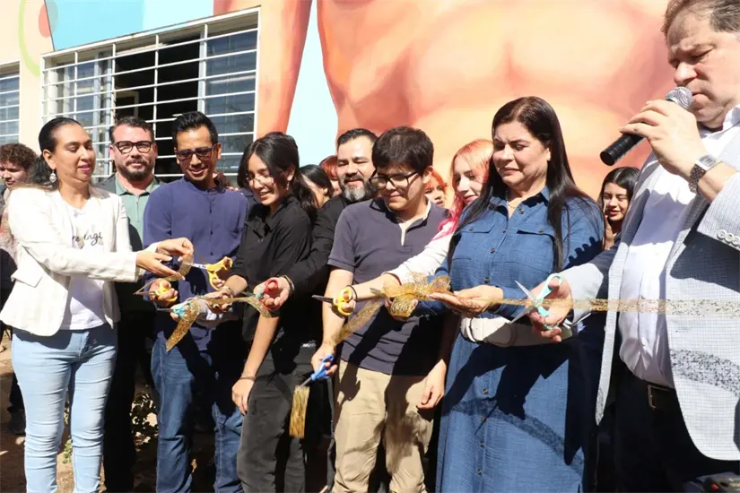 Momento en que todas las partes involucradas en la creación de este mural monumental en la Escuela de Diseño y Artes Visuales de la UAS, realizan el corte del listón.